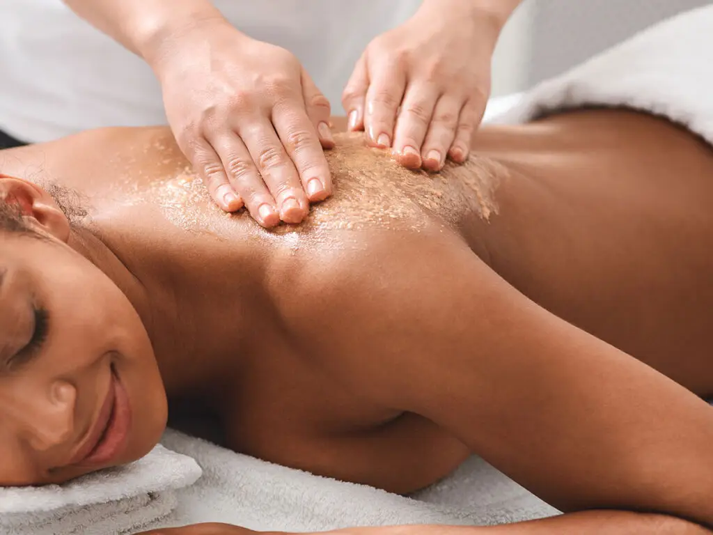 Esthetician performing a body scrub treatment at River City Skin Studio in Chesterfield, VA